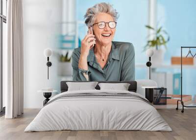 Phone call, communication and laughing with a senior woman sitting in her office, working alone and networking. Contact, mobile and business with a mature female employee joking while speaking Wall mural