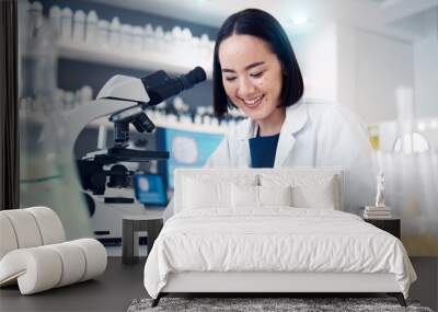 Science, notes and woman in laboratory for data analysis, research and test results with microscope technology innovation. Writing, notebook and asian pharmaceutical pharmacist or scientist in clinic Wall mural