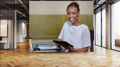 Allow me to make things easier for you. Portrait of a young woman using a digital tablet in a modern office. Wall mural