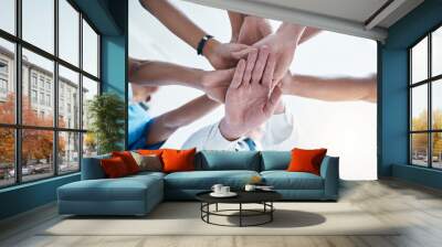 Below, group and hands stack for medical, staff and teamwork in hospital for motivation. Team, doctor and nurse with hand for collaboration, healthcare and help in community at job together in clinic Wall mural