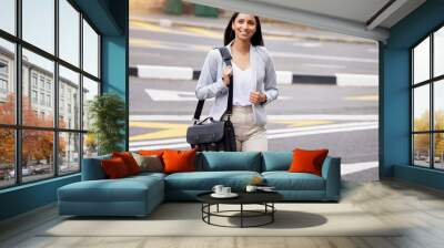 Business woman crossing the street during her walk to work with a briefcase bag outdoors in summer. Happy, corporate and professional employee taking stroll to the company office building in the city Wall mural