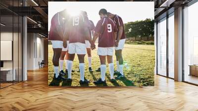 Rugby, field or team in a circle praying for motivation, solidarity or support after sports training. Young men, fitness or group of male athletes in unity before a game or match on a grass stadium Wall mural