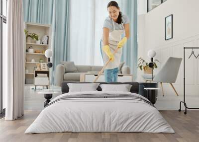 Woman cleaning the floor with a mop in the living room in home with a smile. Happy asian cleaner doing housework or job in a clean lounge, hotel room or house while smiling and alone spring cleaning Wall mural