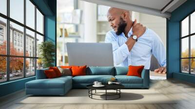 Black man, shoulder pain on laptop in stress and injury suffering from overworking at home. Stressed African male holding sore muscle, tension or joint inflammation sitting with computer and work Wall mural