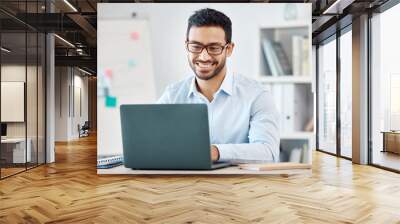 Laptop, design and marketing with a creative business man and nerd working on a computer in his office. Email, internet and creativity with a male employee at work in his modern advertising agency Wall mural