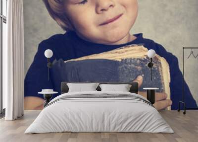 Little boy hugging an old book Wall mural