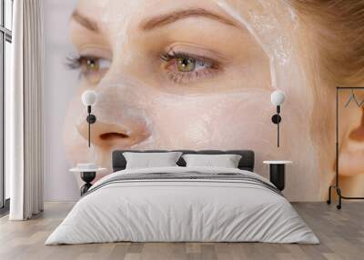 Girl with cream moisture cosmetic on face Wall mural