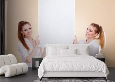 Two girls with blank presentation board Wall mural