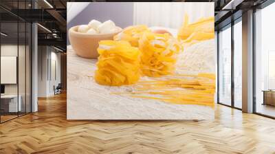 Raw yellow italian pasta pappardelle, fettuccine or tagliatelle Wall mural