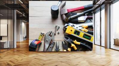 Hardware tools, equipment used for repair and maintenance work in general technicians isolated on wooden background closeup. Wall mural