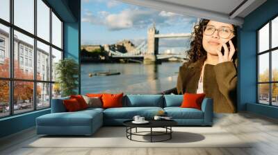 London business woman happy on smart phone. Wall mural