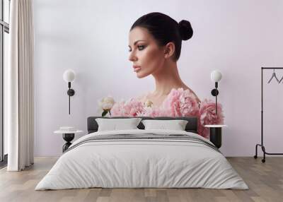 Beautiful brunette woman with peony flowers. Natural cosmetics and makeup, perfect skin Wall mural