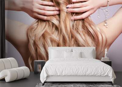 Beautiful strong hair of a woman, strengthening and restoring the hair roots. Beautiful manicure on the hands of a girl Wall mural