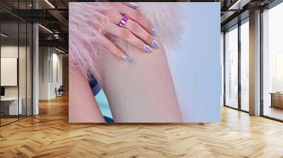 Close-up womans leg, showing tattoo reading Stay With Me Tonight. Woman hand is visible in upper left corner, wearing pink ring and showcasing light blue nail polish Wall mural