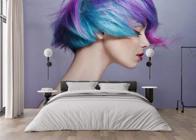 Portrait of a woman with bright colored flying hair, all shades of purple. Hair coloring, beautiful lips and makeup. Hair fluttering in the wind. Sexy girl with short hair Wall mural