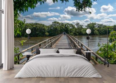 Argentina, wooden bridge crossing the Iguazu River on  a walk path . Wall mural