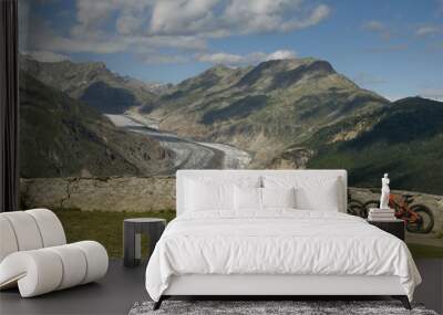 view of Aletsch Glacier, in foreground two electric mountain bikes, ebike e-bikes, leaning on the wall of the scenic spot, in the distance jungfraujoch, eggishorn, eiger, summer, belalp, switzerland Wall mural