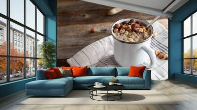 Porridge with hazelnuts in a enamel cup with spoon Wall mural