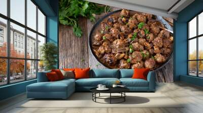 Rustic pan dish with meatballs in a delicious mushroom sauce Wall mural