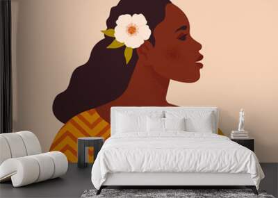 Beautiful black woman. Young african american. Portrait of young woman with beautiful face and hair. Side view. Isolated on a beige background. Wall mural