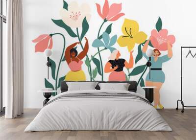 Women diverse of different ethnicity are wonder the huge spring wild flowers. Spring vibes mood. International Womens Day. Wall mural