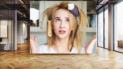 Girl trying to comb her hair Wall mural