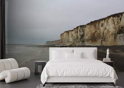 the coast of normandy with big white cliffs along the sea at a stormy day Wall mural