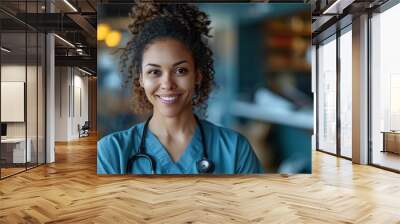 Portrait of a young smiling female doctor in a hospital, wearing medical uniform and stethoscope in a healthcare environment Wall mural