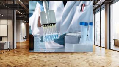 research technician with multipipette in genetic laboratory / hands of scientist working with multichannel pipette and multi well plates Wall mural