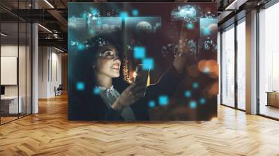 Woman, tech overlay and phone in night at office for finance research, data analytics or digital job. Cybersecurity expert, fintech or focus in dark workplace with 3d hologram abstract with happiness Wall mural