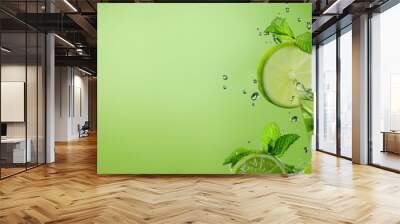 Ice-cold Mojito cocktail with mint and lime explosion, and splashes, panoramic green banner with copy space Wall mural