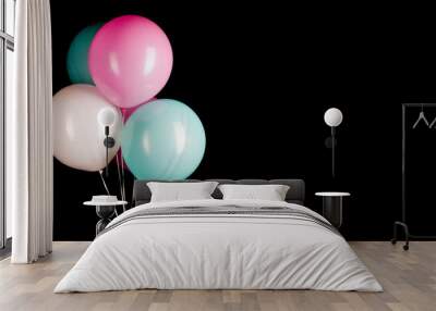 A group of colorful party balloons on a black background with copy space Wall mural