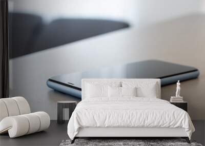 A single mobile phone on gray table Wall mural