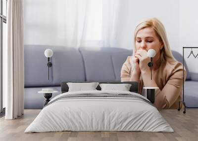 a woman on her knees prays at home Wall mural