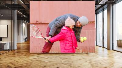 Active family playing tennis on court Wall mural