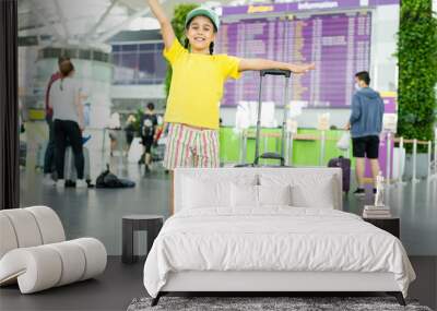 Adorable little girl at airport with suitcase Wall mural