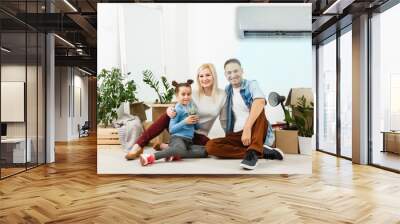 air conditioning in living room with happy family moving to new apartment Wall mural