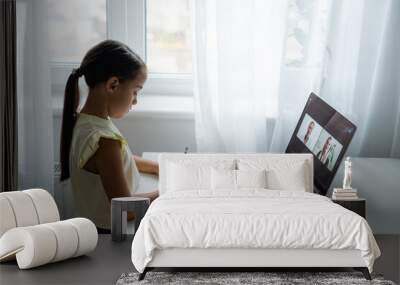 cheerful young little girl children using laptop computer, studying through online e-learning system Wall mural