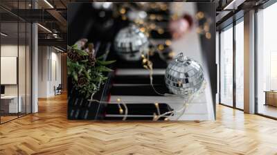 Christmas ball on piano keys. Carol music concept Wall mural