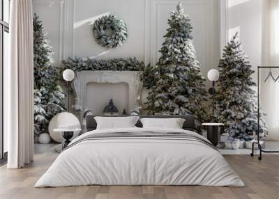 Christmas tree is dressed up in a white room. On the Christmas tree colored balls of blue and pink. The concept of celebration and fun. Wall mural