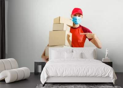 delivery man in protective mask with parcel post box isolated over white background. Wall mural