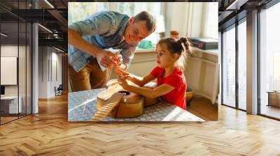 father and daughter repairing a guitar Wall mural