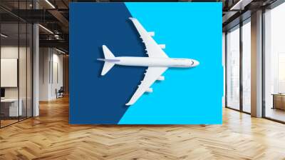 Flat lay design of travel concept with plane on blue background with copy space Wall mural