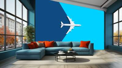 Flat lay design of travel concept with plane on blue background with copy space Wall mural