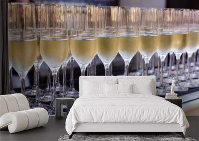 Glasses with champagne lined up during banquet or party Wall mural