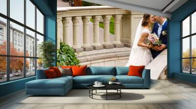 Happy bride and groom in a castle on their wedding day Wall mural