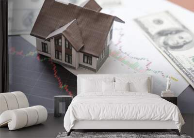 Home mortgage concept - house with up and down graph on the background Wall mural