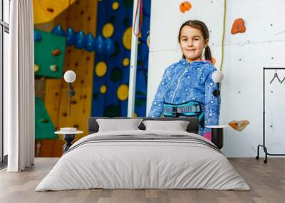 Little girl climbing a rock wall indoor Wall mural