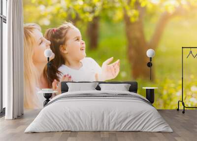 Mother and daughter in field with colorful flowers Wall mural