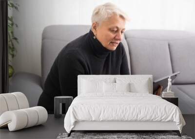 Old woman using blank screen tablet. Wall mural